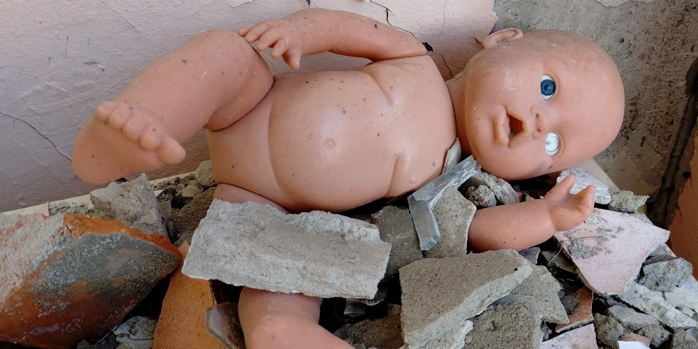 Doll under rubble in ruined nursery North Saltyvka, Kharkiv. Photo by Oleg Dmitriev
