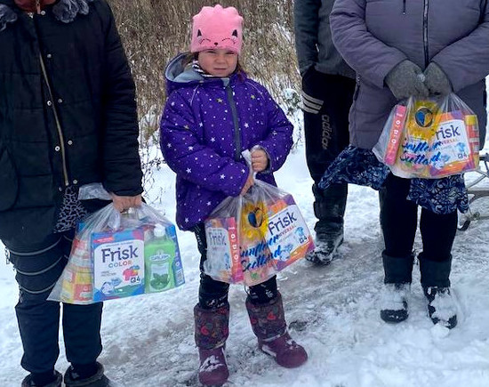 Young girl in Virivka, Kharkiv Oblast, receives humanitarian aid from Sunflower Scotland