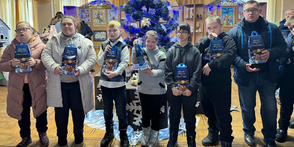 Disabled Ukrainian children holding chocolate gift sets at a Christmas concert organised by charities Sunflower Scotland (UK) and Shira Sprava (Ukraine) in Kryvyi Rih, south Ukraine