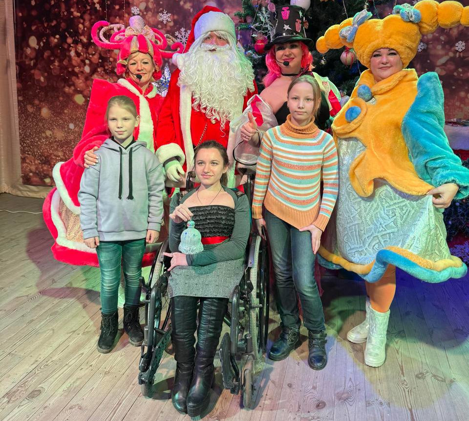 Disabled Ukrainian child in wheelchair and two girls with Santa Claus and actors at a concert organised by charities Sunflower Scotland (UK) and Shira Sprava (Ukraine) in Kryvyi Rih