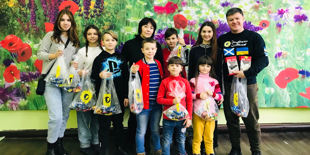 Sunflower Scotland delivers Christmas gifts to orphan kids in Krasnokutsk, Kharkiv Region, received by Natalia, a fostering parent, children, meeting Vitalyi Grygorov, Sunflower's volunteer