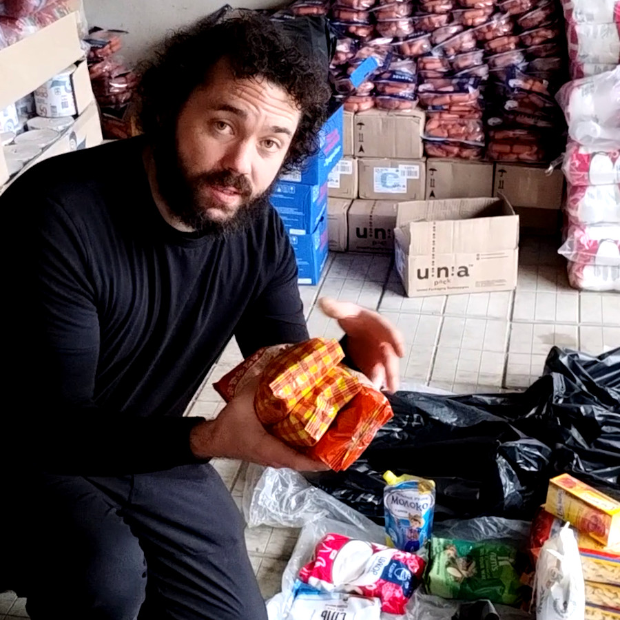 David Sharkey packing a bag of aid for frontline villages in Kharkiv Oblast, Ukraine