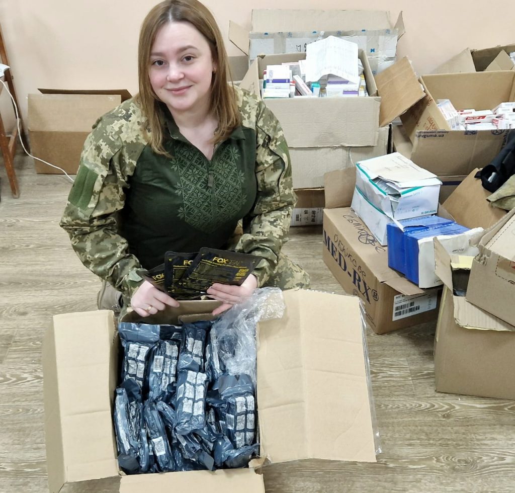 Ukrainian defence medic with a box of Israeli bandages delivered by Sunflower Scotland