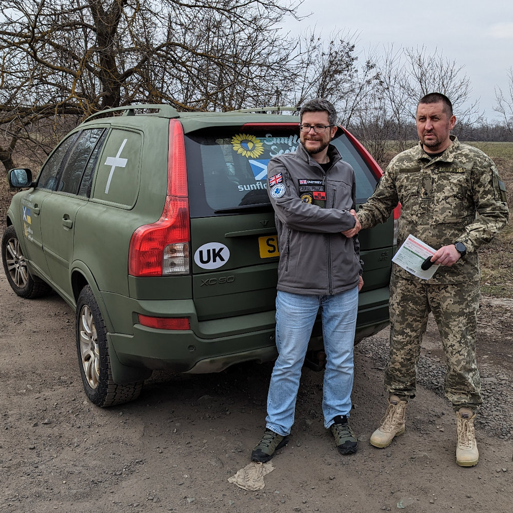 Oleg Dmitriev, Sunflower Scotland, delivers Voilvo to the 129th brigade TRO and shakes hands with soldier