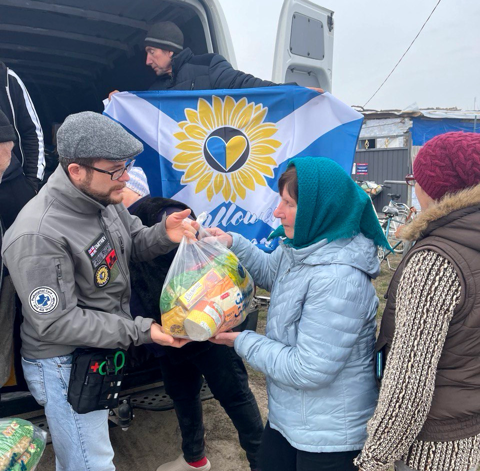 Female resident of the Osokorivka village gathered around the aid delivery van, Sunflower Scotland and Shira Sprava delivering humanitarian aid