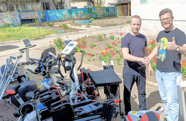 Oleg Dmitriev, chairman of Sunflower Scotland, brings donation of 8 rehabilitation machines and 5 wheelchairs to rehabilitation machines to Pershotravensk, Ukraine, 40 miles from the front line, with Yuriy Dibrova, elected representative from Pershotravensk