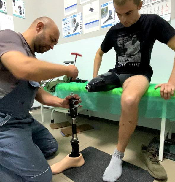Rehabilitation doctor attaching a prosthetic limb in a rehab in Dnipro