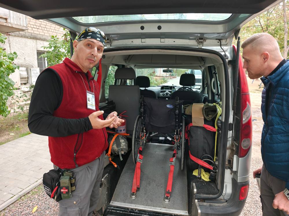 Dima and Ihor are standing near patient transport car