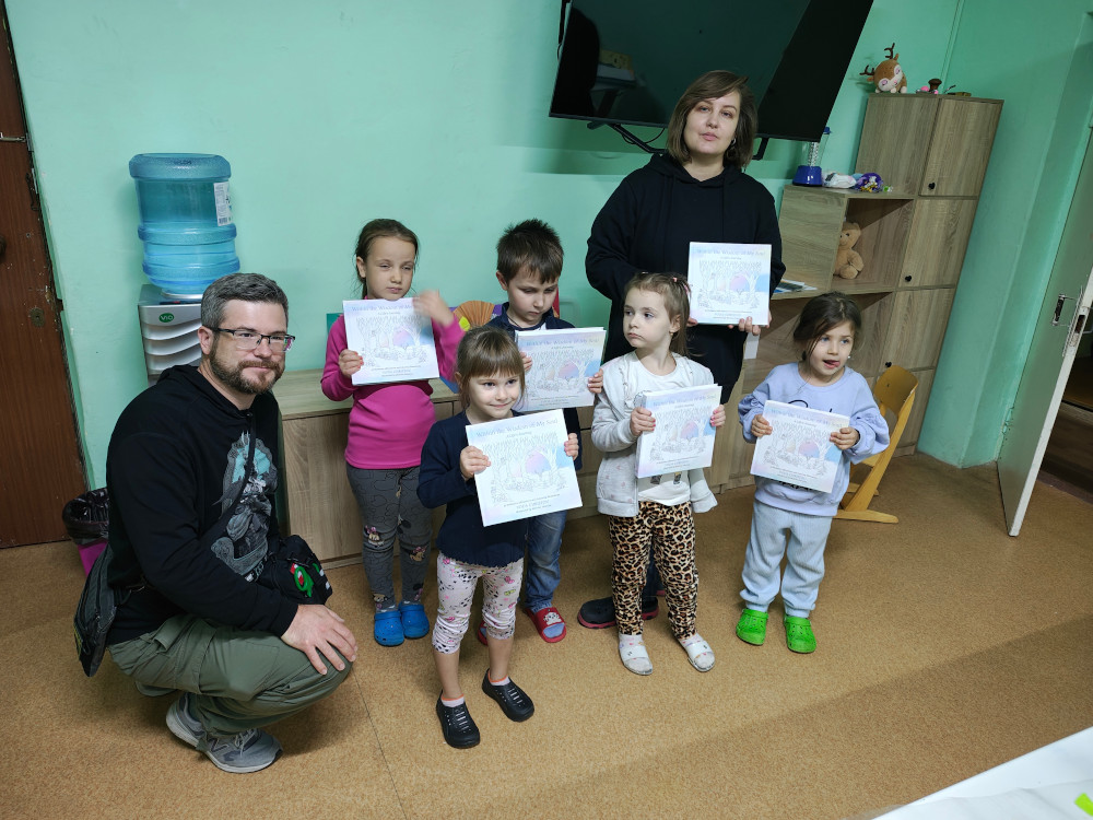 Kherson - children receiving Yoda Christou's colouring books