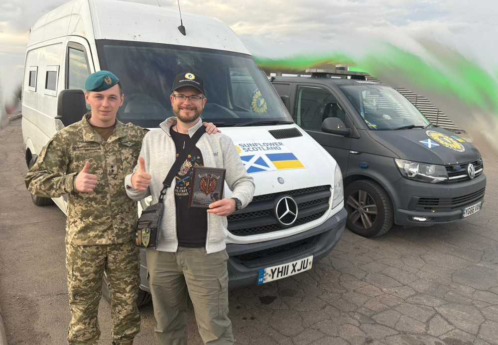 Oleg receives plaque of recognition from the 30th Marine Corps