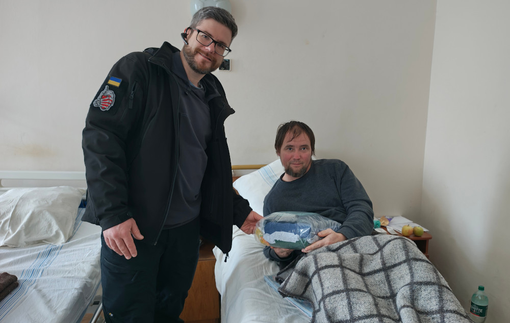 Sunflower donating clothing to a wounded soldier in Kharkiv hospital