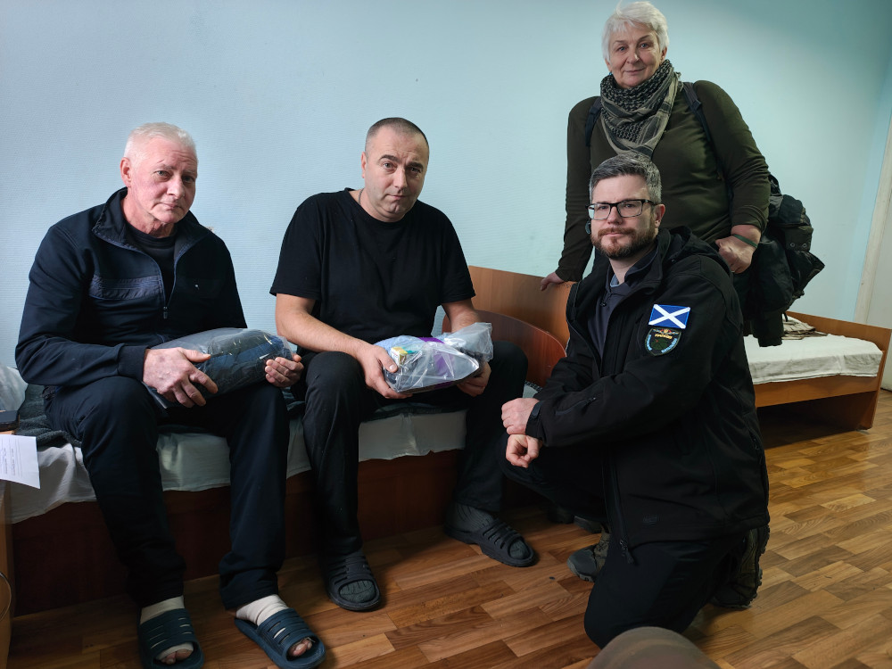 Sunflower donating clothing to a wounded soldier in Kharkiv hospital