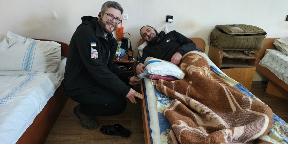 Sunflower donating clothing to a wounded soldier in Kharkiv hospital