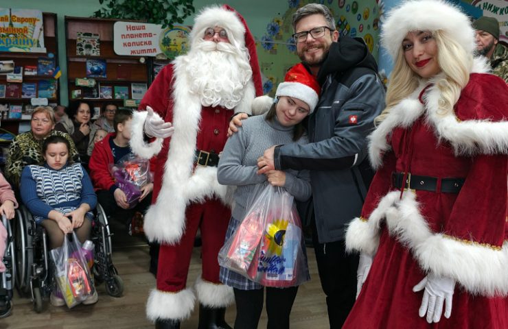 A child with special needs in Kryvyi Rih receiving a Christmas gift from Sunflower Scotland