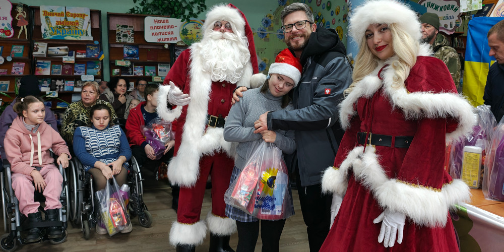 A child with special needs in Kryvyi Rih receiving a Christmas gift from Sunflower Scotland