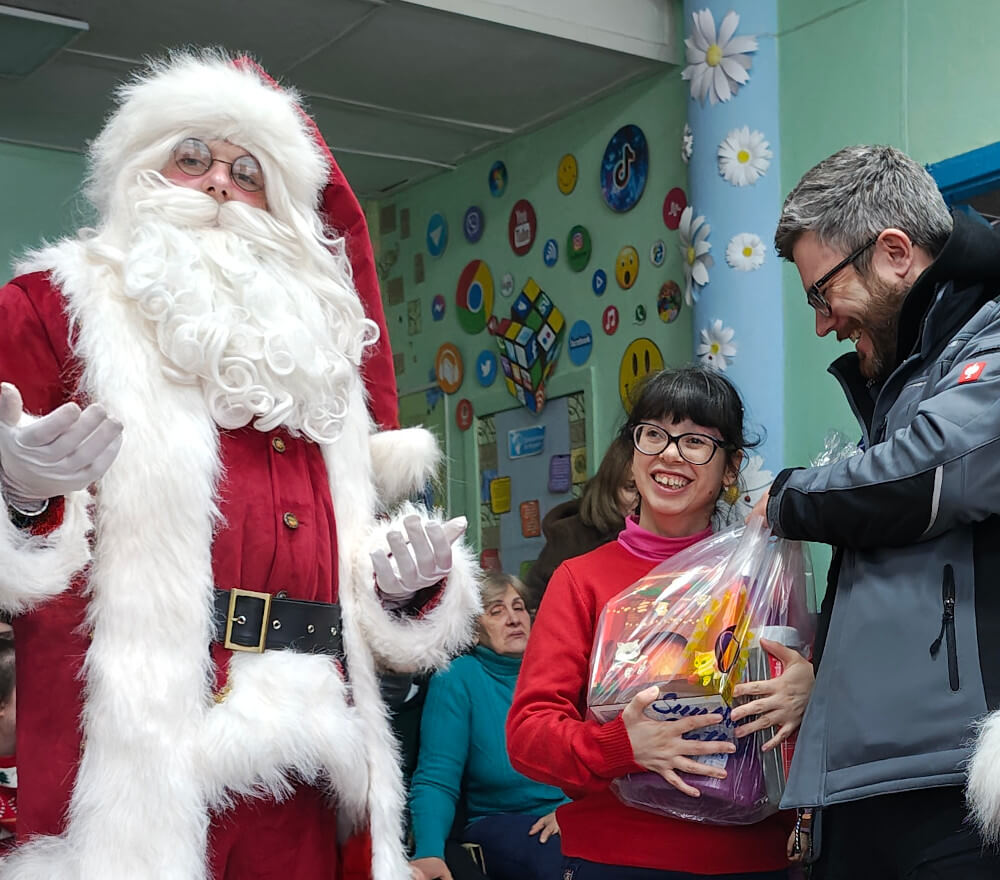 A child with special needs in Kryvyi Rih receiving a Christmas gift from Sunflower Scotland
