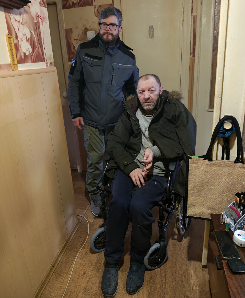 Disabled person in wheelchair in Sumy region receiving jacket from Hoggs of Fife