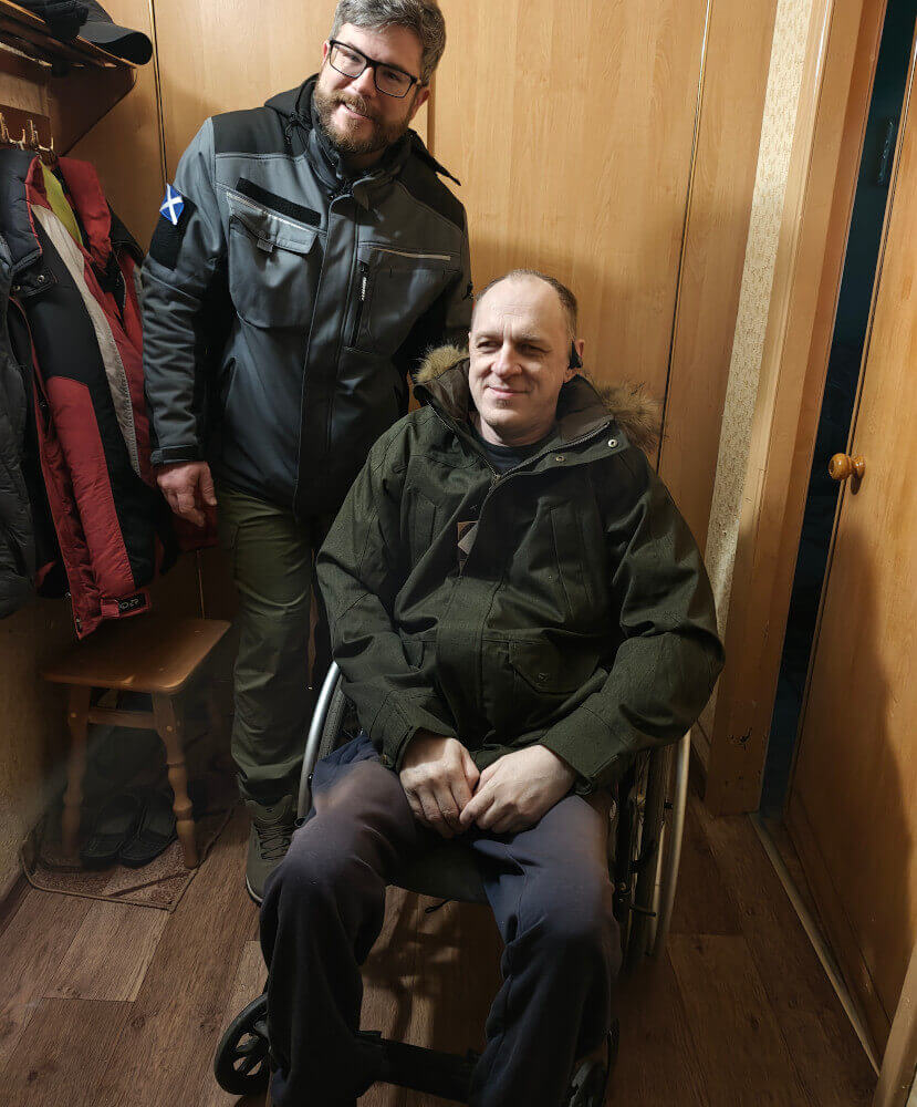 Disabled person in wheelchair in Sumy region receiving jacket from Hoggs of Fife