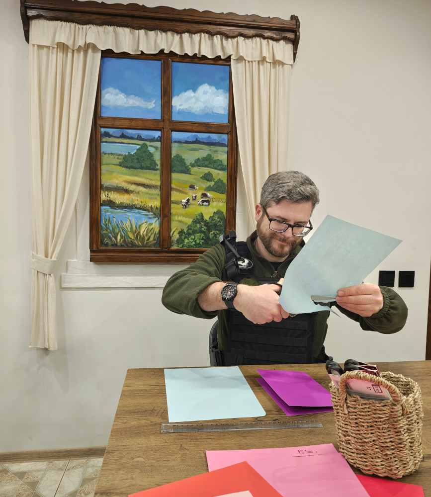 Oleg making Valentine's card at the KRYLA art hub in Kherson