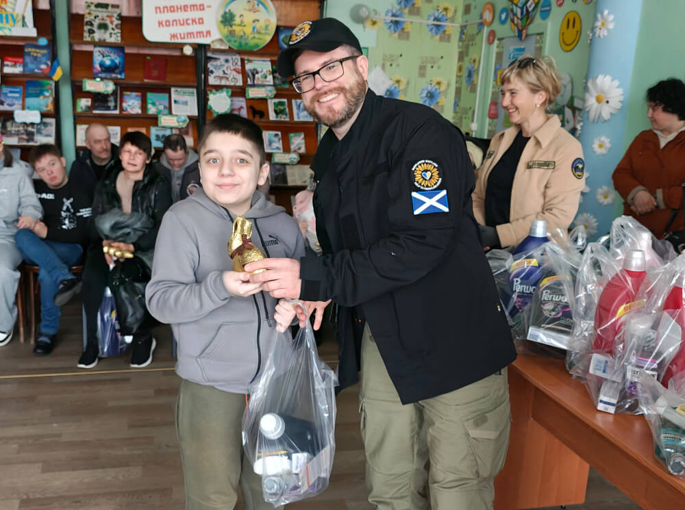Child with a disability receiving Easter present and humanitarian aid