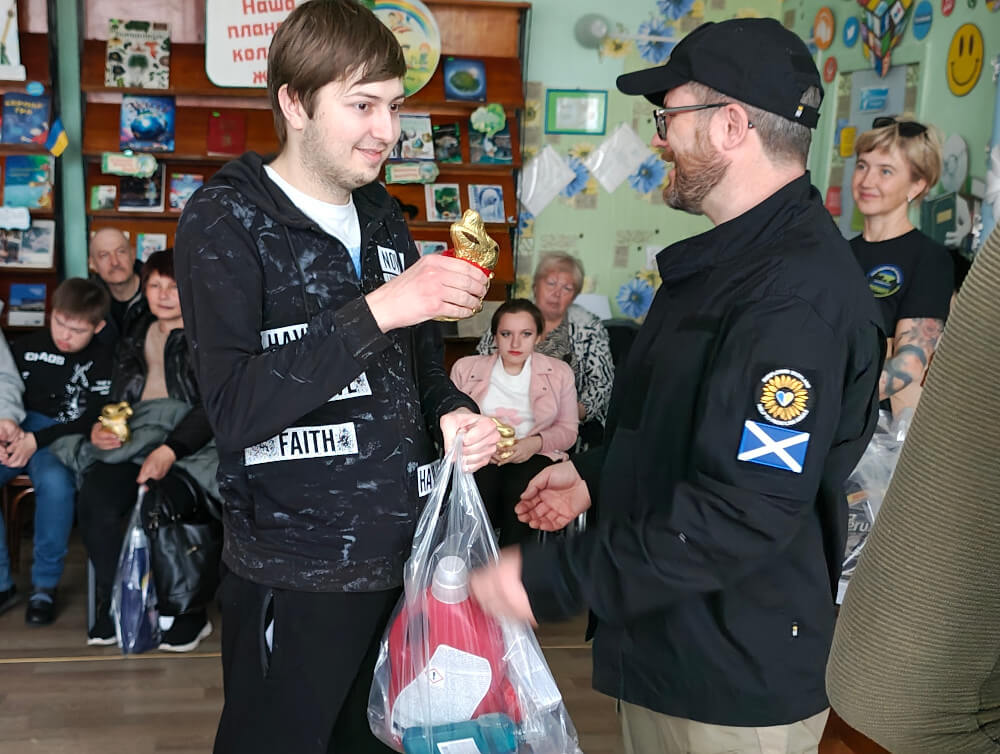 Child with a disability receiving Easter present and humanitarian aid