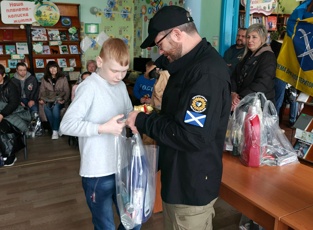 Child with a disability receiving Easter present and humanitarian aid
