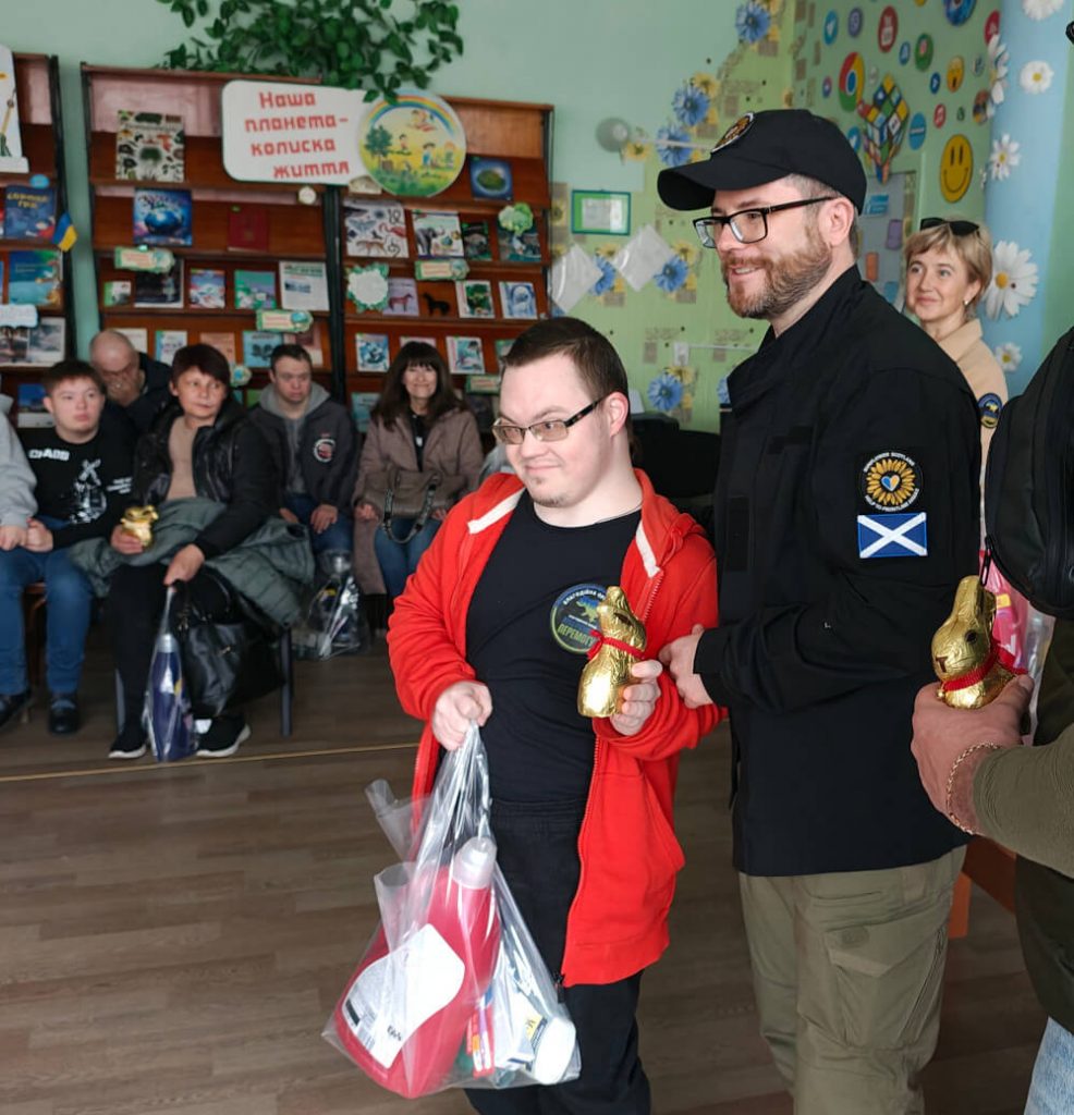 Child with a disability receiving Easter present and humanitarian aid