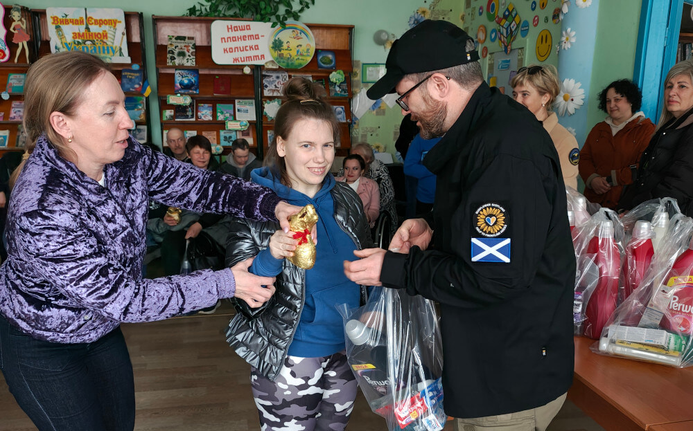 Child with a disability receiving Easter present and humanitarian aid