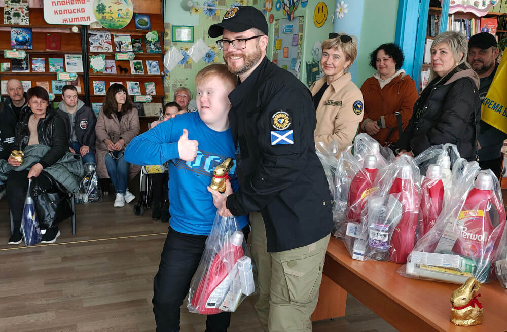 Child with a disability receiving Easter present and humanitarian aid