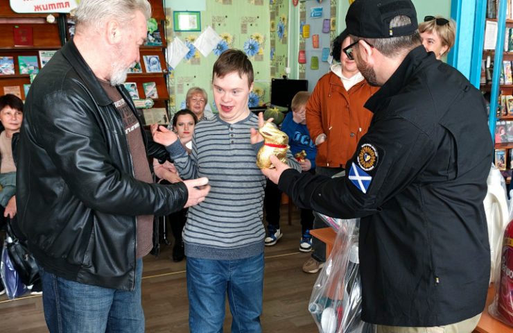Child with a disability receiving Easter present and humanitarian aid