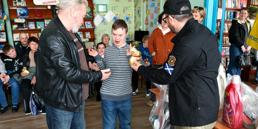 Child with a disability receiving Easter present and humanitarian aid