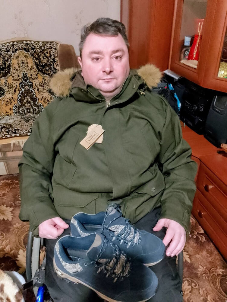 Disabled person in wheelchair in Sumy region receiving jacket from Hoggs of Fife