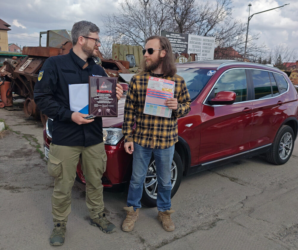Oleg, head of Sunflower Scotland, donating BMW car to Kraken in Kharkiv