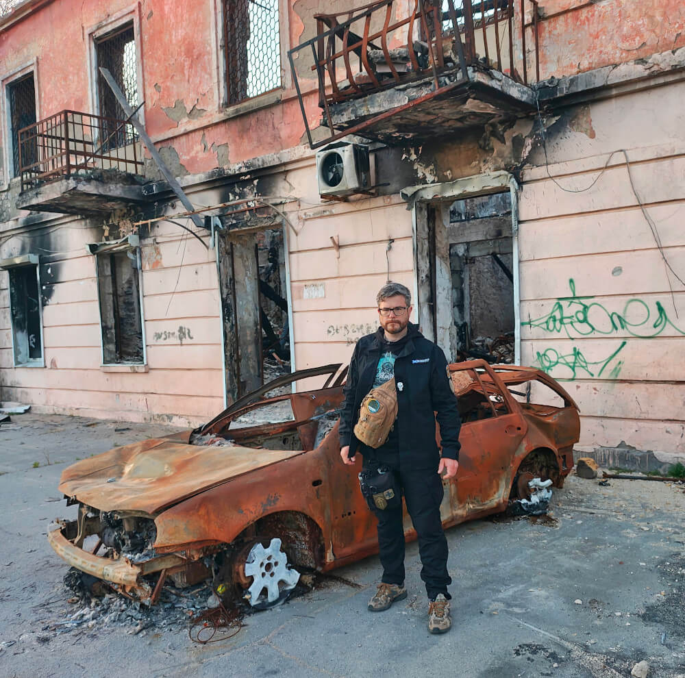 Burnt car in front of destroyed house in Kherson