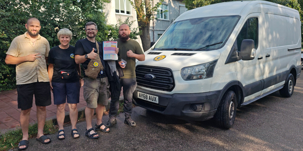 Alison and Oleg of Sunflower Scotland donating Ford Transit van to medics in a field hospital near Zaporizhzhia