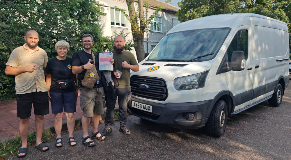 Alison and Oleg of Sunflower Scotland donating Ford Transit van to medics in a field hospital near Zaporizhzhia