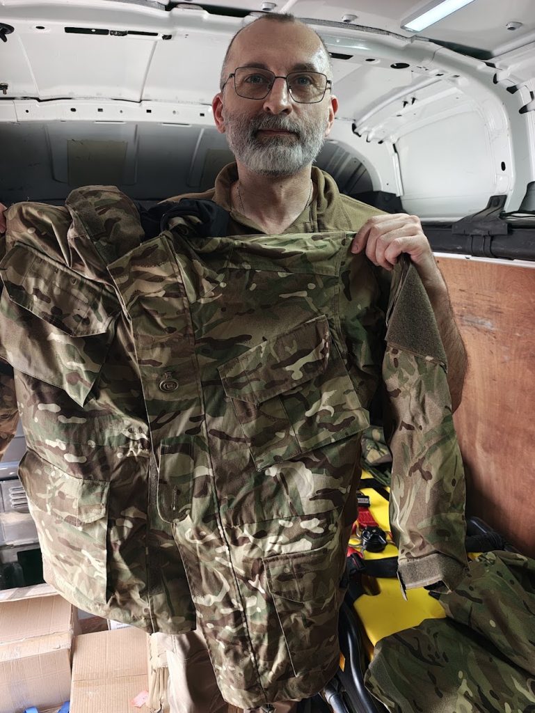 Head medic of Arei 253 Assault Regiment receiving British Gore-tex uniforms from Sunflower Scotland